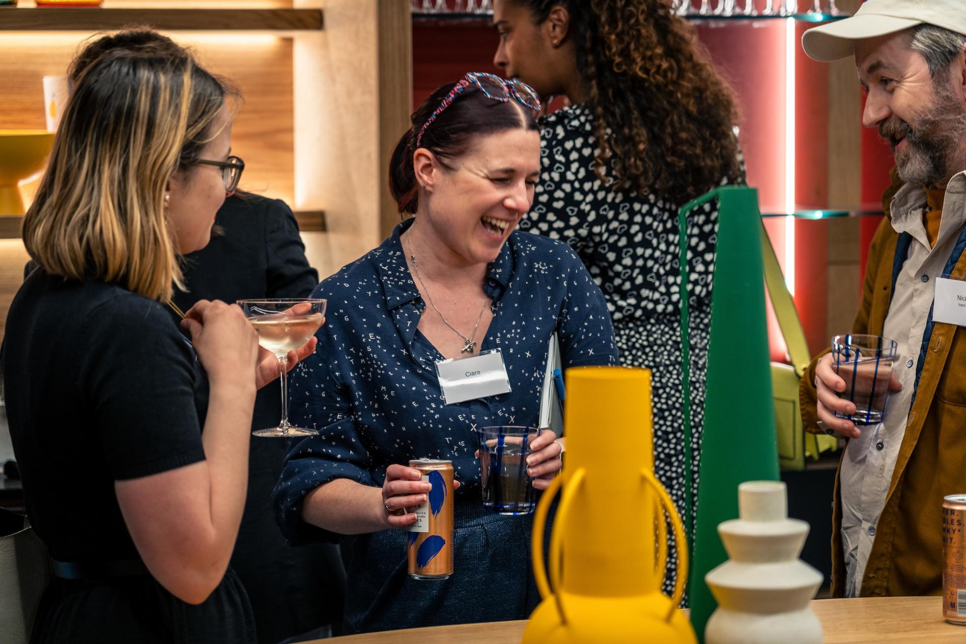 Attendees enjoy drinks while networking at the Glasgow Property Outlook event, surrounded by vibrant decor.