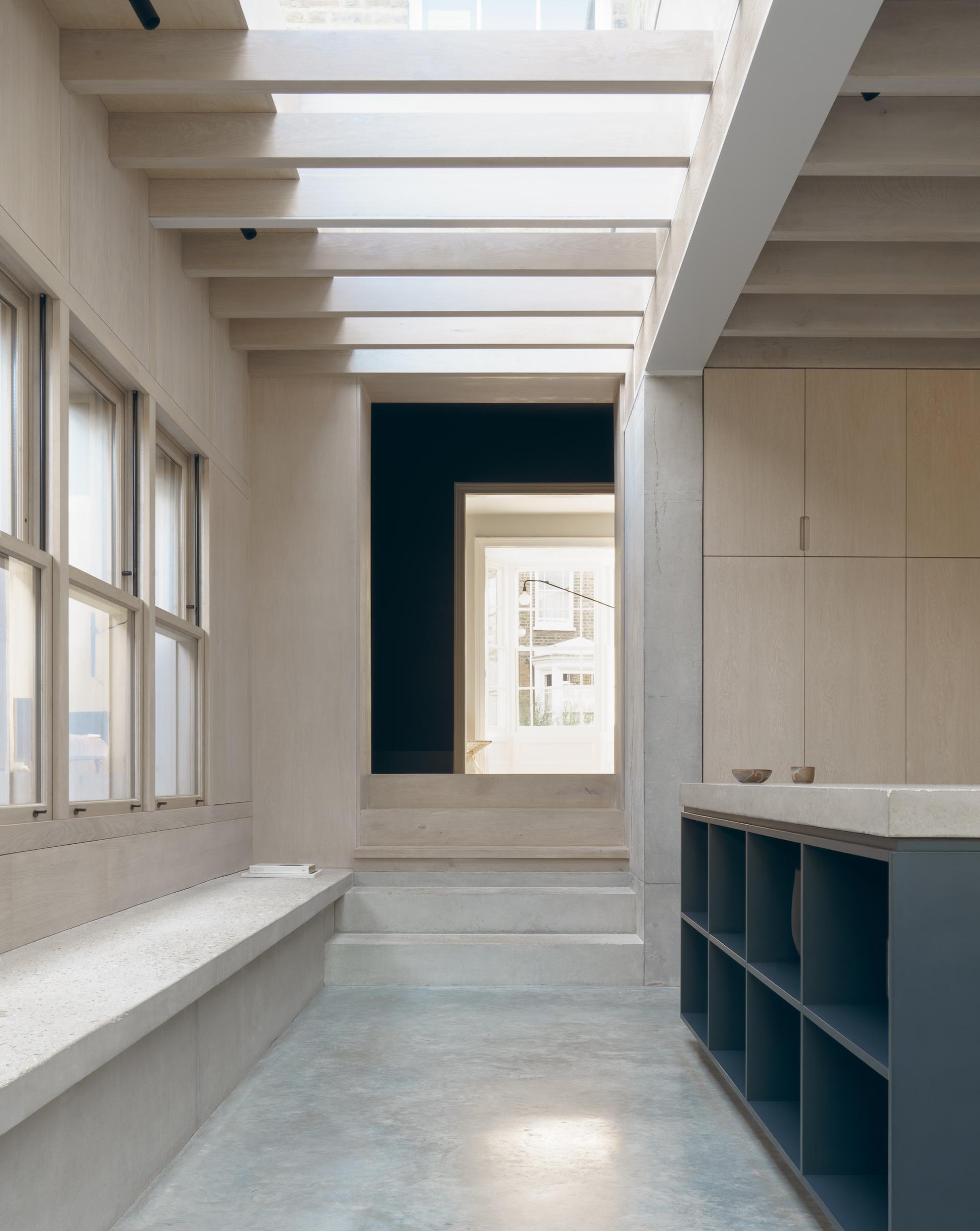 Modern interior of Concrete Plinth House featuring open space, natural light, and minimalist design elements by DGN Studio.