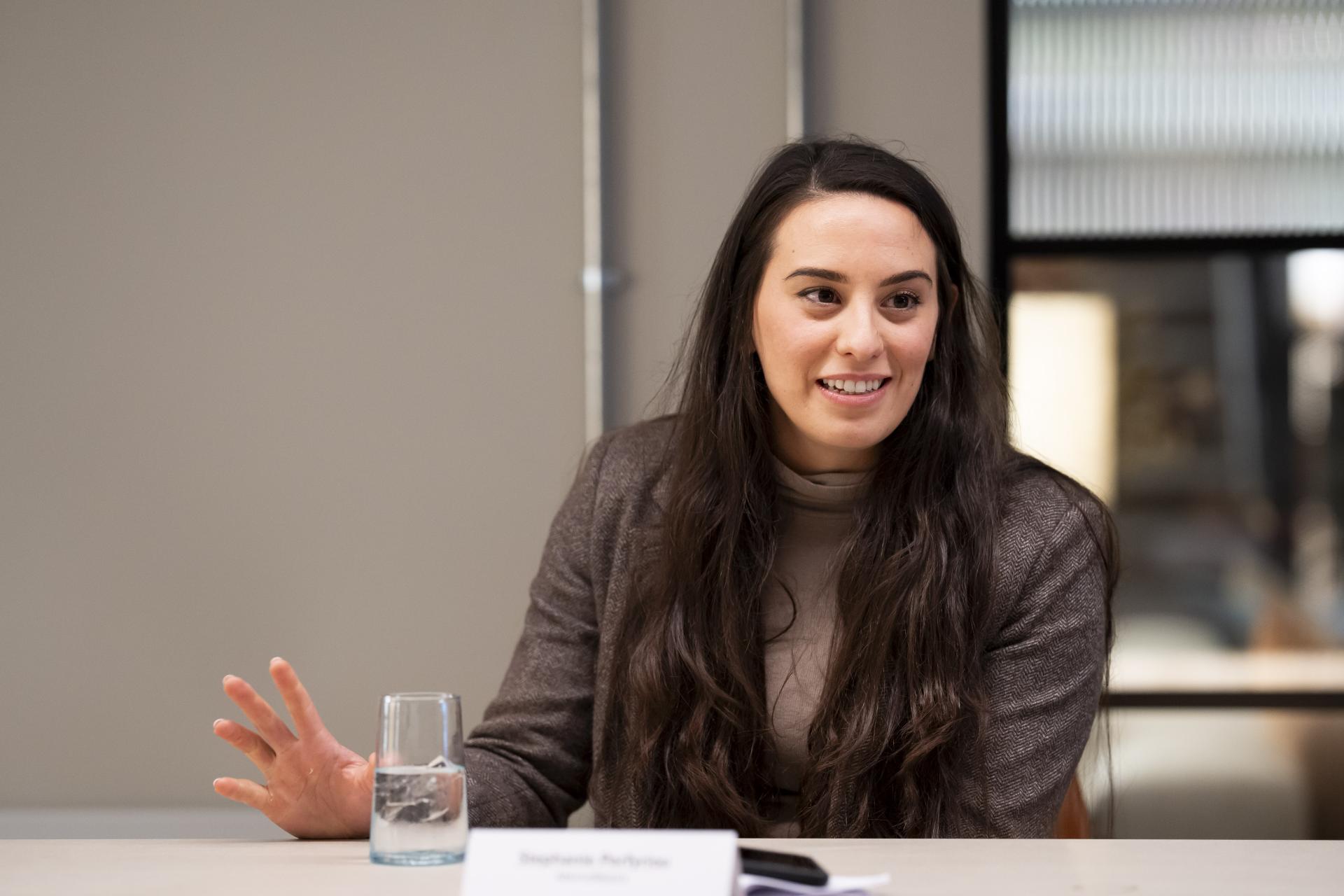 A woman engages in conversation at a workplace discussion about the impact of data on technology and collaboration.