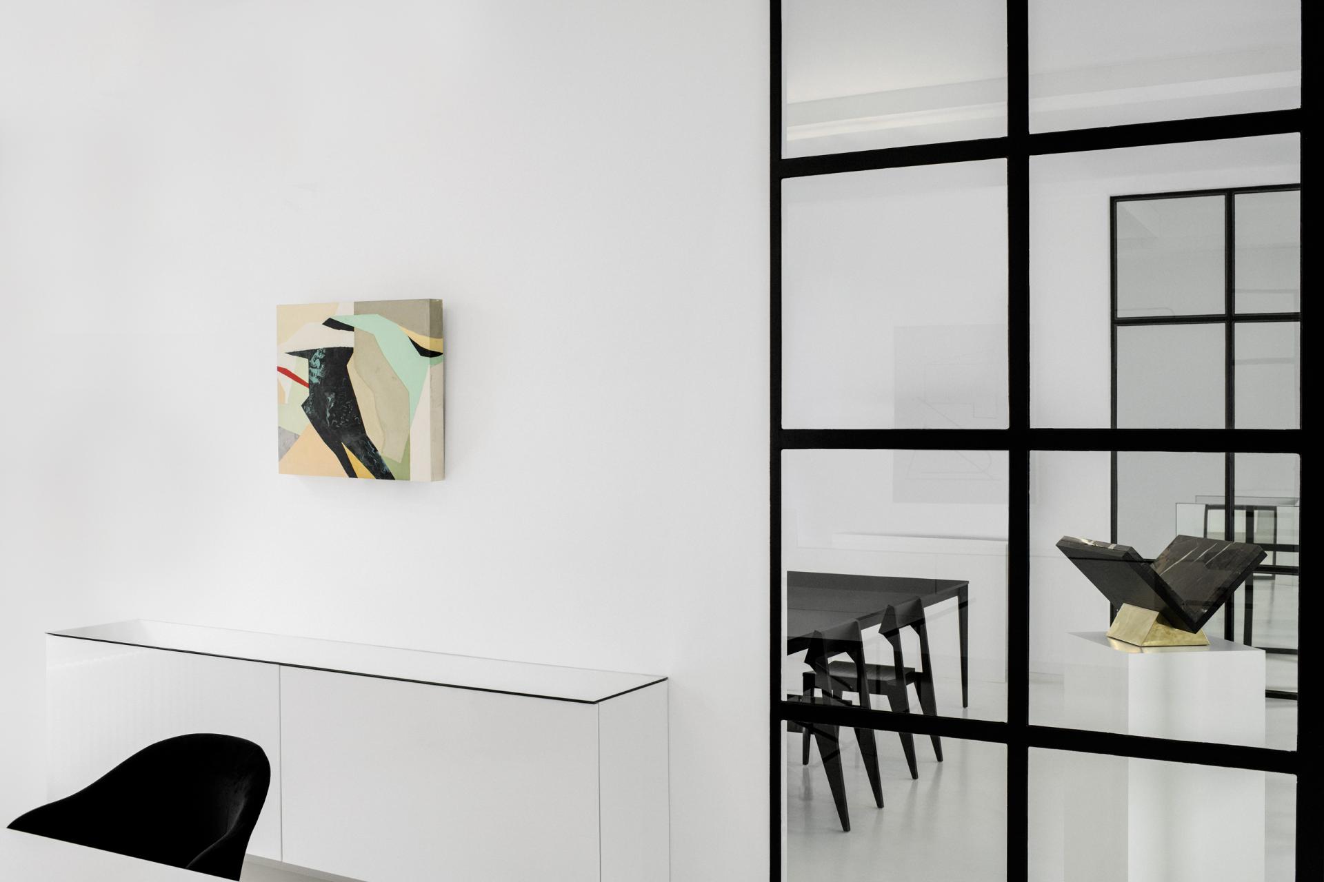 Modern interior of Peoplegrapher Düsseldorf showcasing experimental design elements, including minimalist furniture and abstract art.