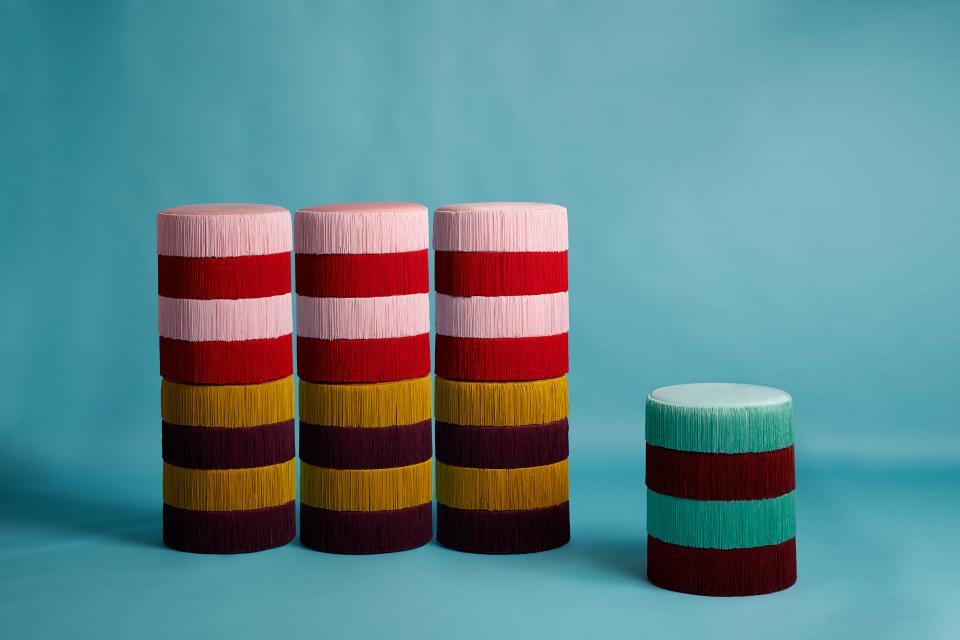 Colorful vintage-inspired stools designed by Masquespacio and Houtique, featuring layered fringed textures against a pastel background.