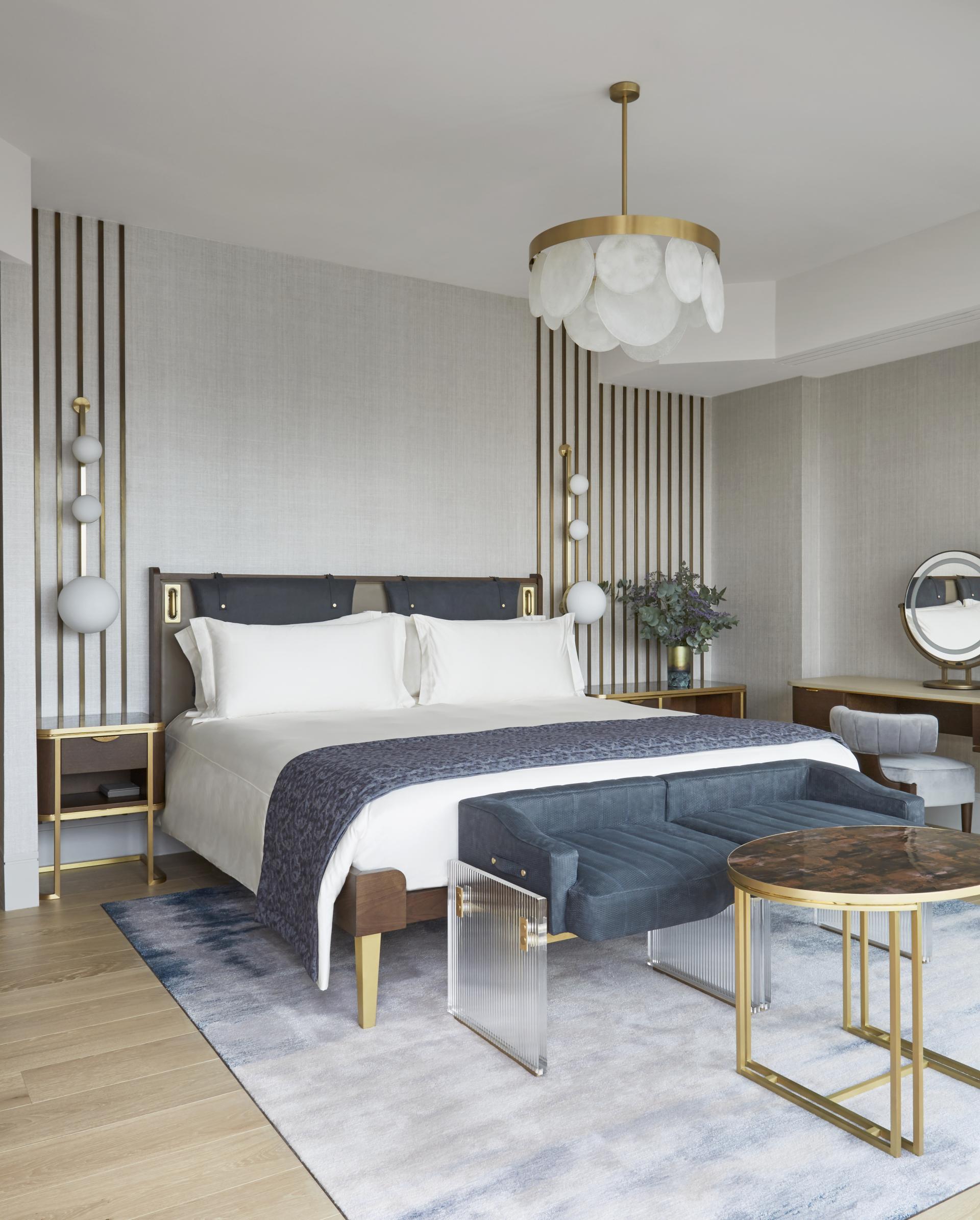 Luxuriously designed penthouse bedroom featuring elegant furnishings, a stylish chandelier, and sophisticated decor at Mandarin Oriental London.