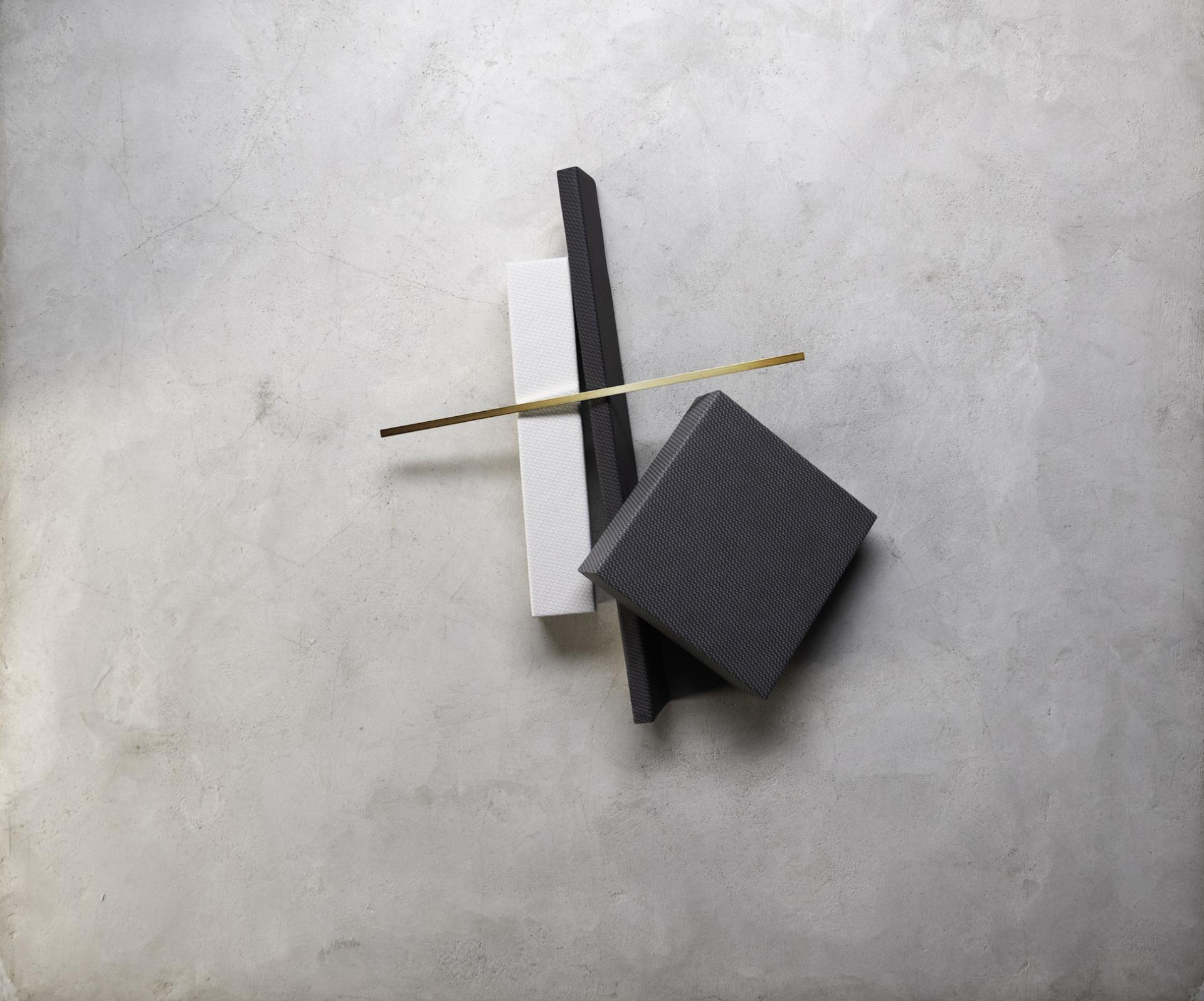 Bauhaus-inspired performance textiles in black, white, and textured materials showcased on a gray surface.