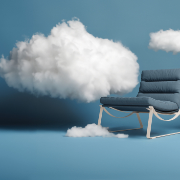 Breathable Ultrafabrics Ellora chair positioned among soft, fluffy clouds against a serene blue background.