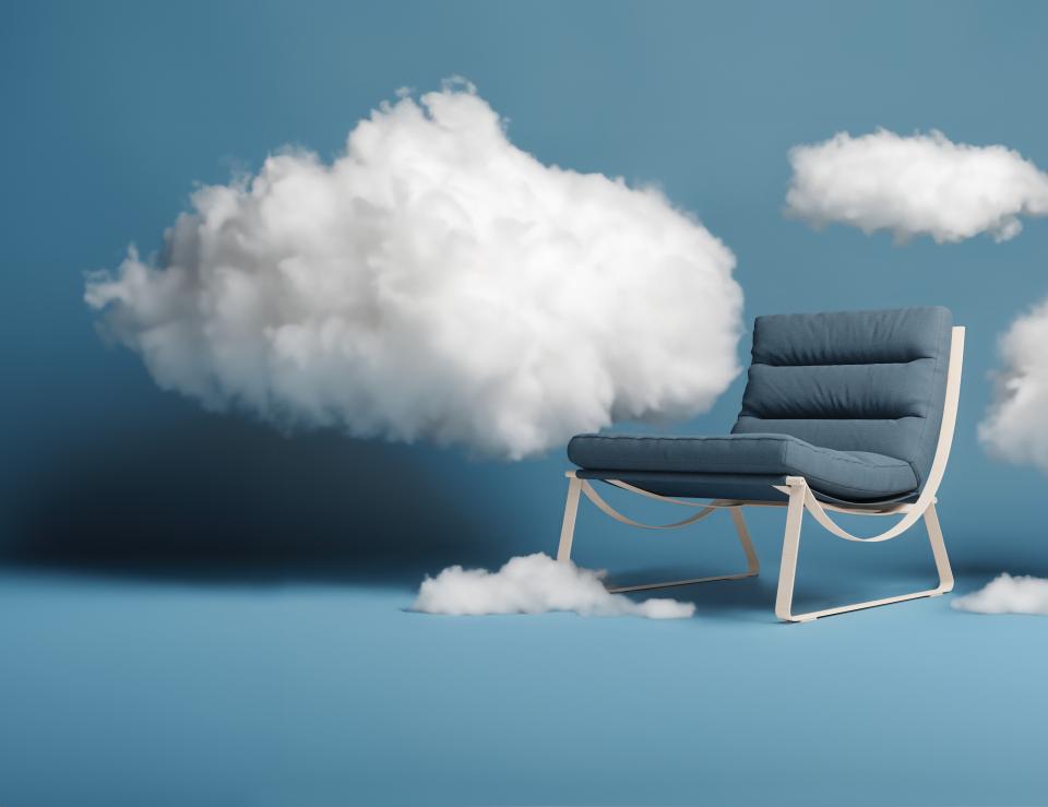 Breathable Ultrafabrics Ellora chair positioned among soft, fluffy clouds against a serene blue background.