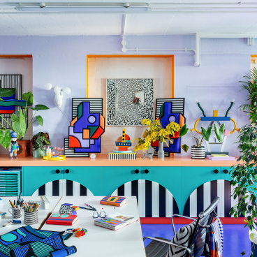Vibrant studio interior showcasing Camille Walala's distinctive geometric art, colorful decor, and creative workspace elements.