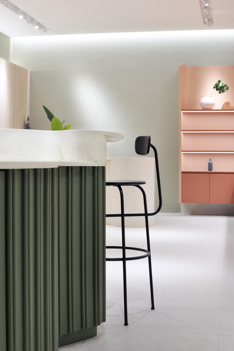 Sculptural interior of an organic skincare flagship store featuring soft curves, textured surfaces, and minimalist design elements.