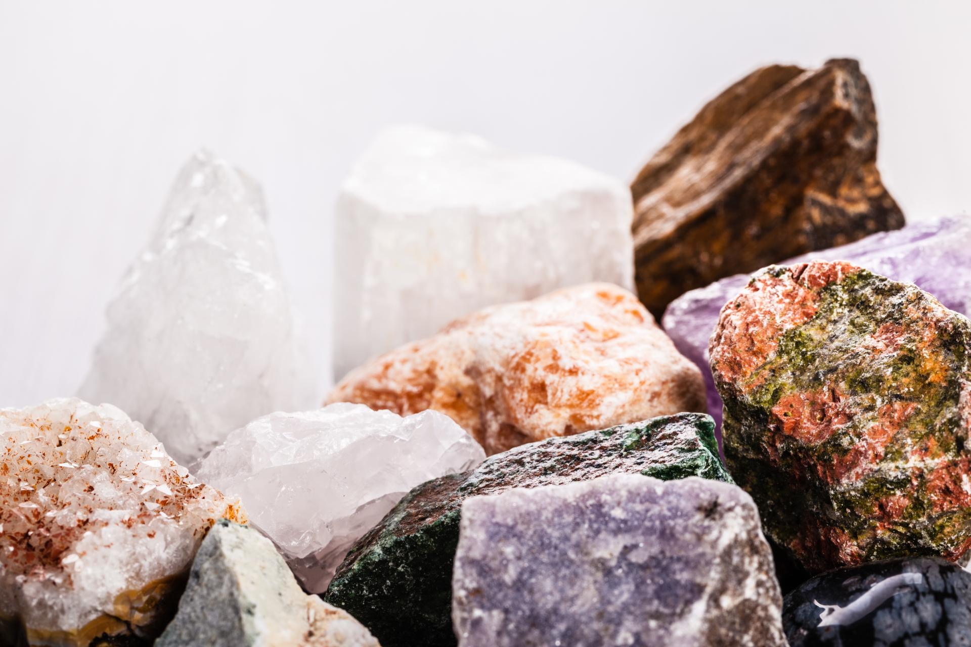 A close-up view of various colorful gemstones and minerals, showcasing their unique textures and shapes relevant to Bute Fabrics.