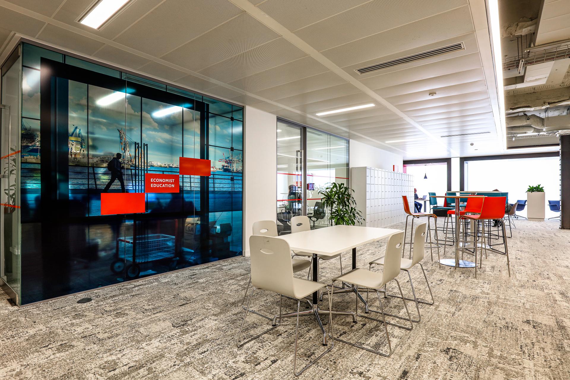 Modern office interior designed for The Economist Group featuring collaborative spaces and eco-friendly design elements.