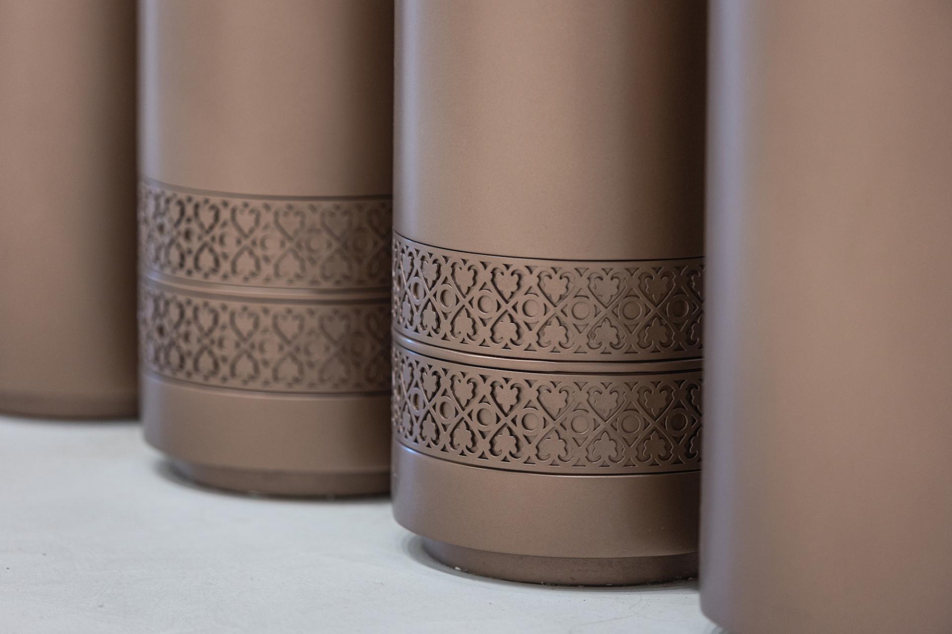 Elegant Rajasthani-inspired decorative details on cylindrical elements in Jaipur Rugs' Dubai showroom design.