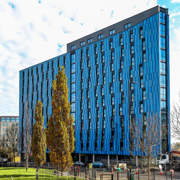 Modern student accommodation building Bath Court by Robert Hirschfield Architects, featuring a striking blue facade in Birmingham.
