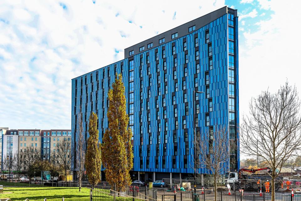 Modern student accommodation building Bath Court by Robert Hirschfield Architects, featuring a striking blue facade in Birmingham.