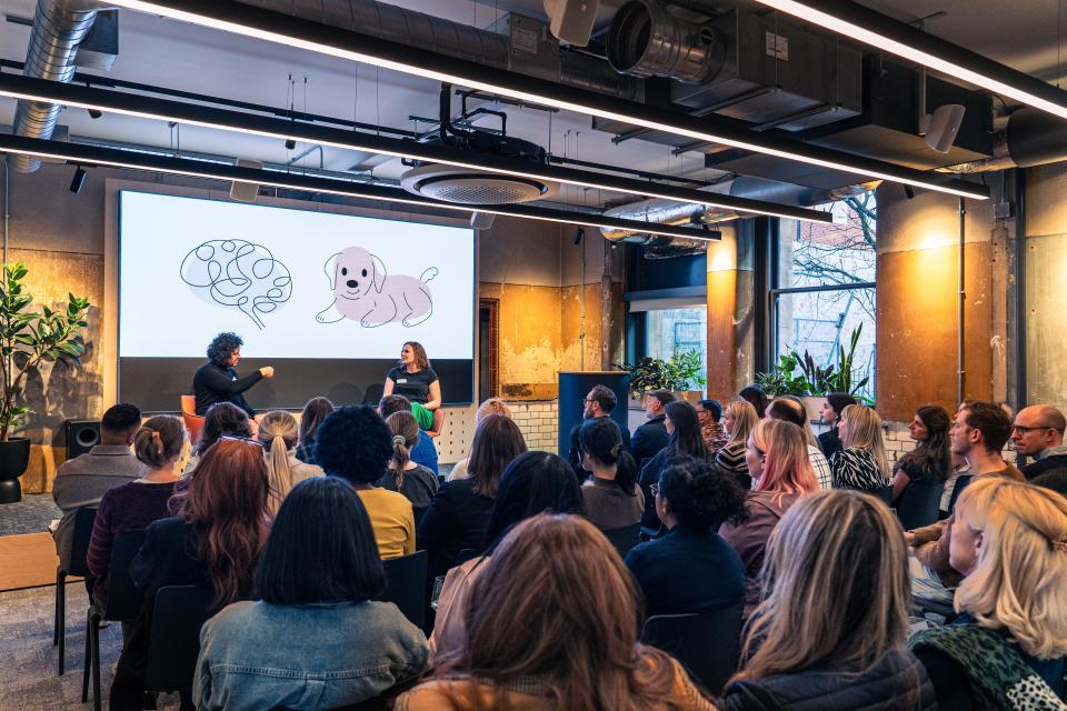 Dr. Stephanie Fitzgerald discusses EDI concepts with engaging visuals while a diverse audience actively listens.