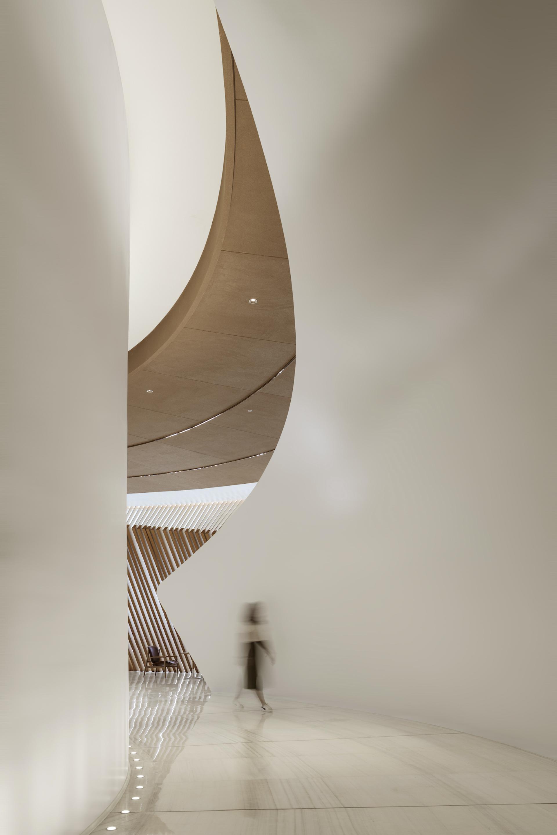 Flowing architectural curves mimic flower petals in The Florescence's interior design in Guangzhou.