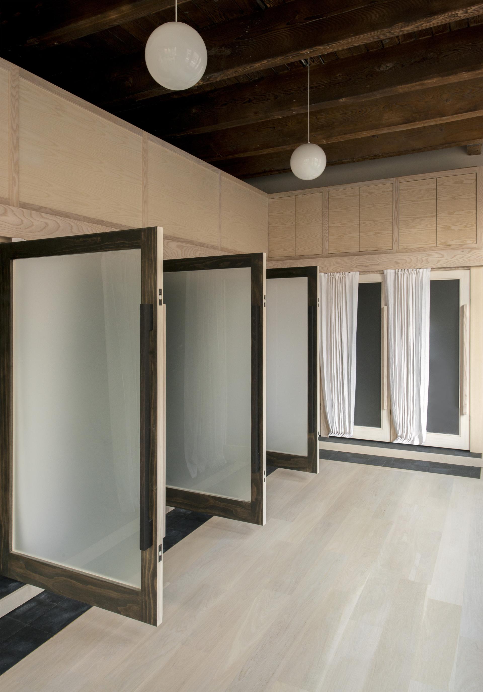 Flexible loft space in Pioneer Square features stylish frosted glass doors, light wood floors, and modern design elements.