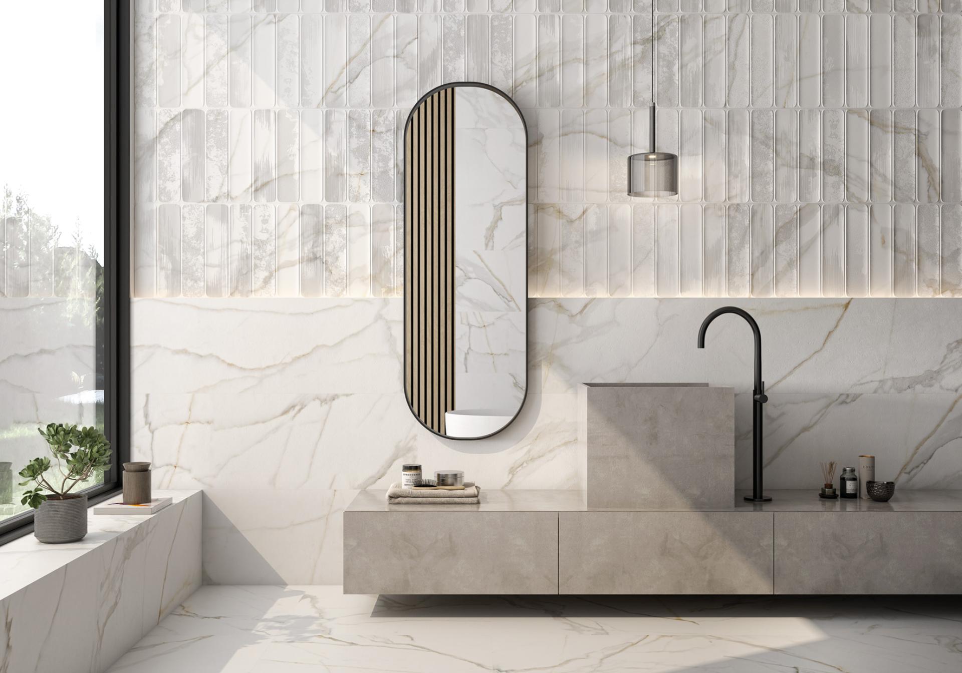 Elegant bathroom featuring contemporary tile design with marble accents, modern sink, stylish mirror, and natural light.