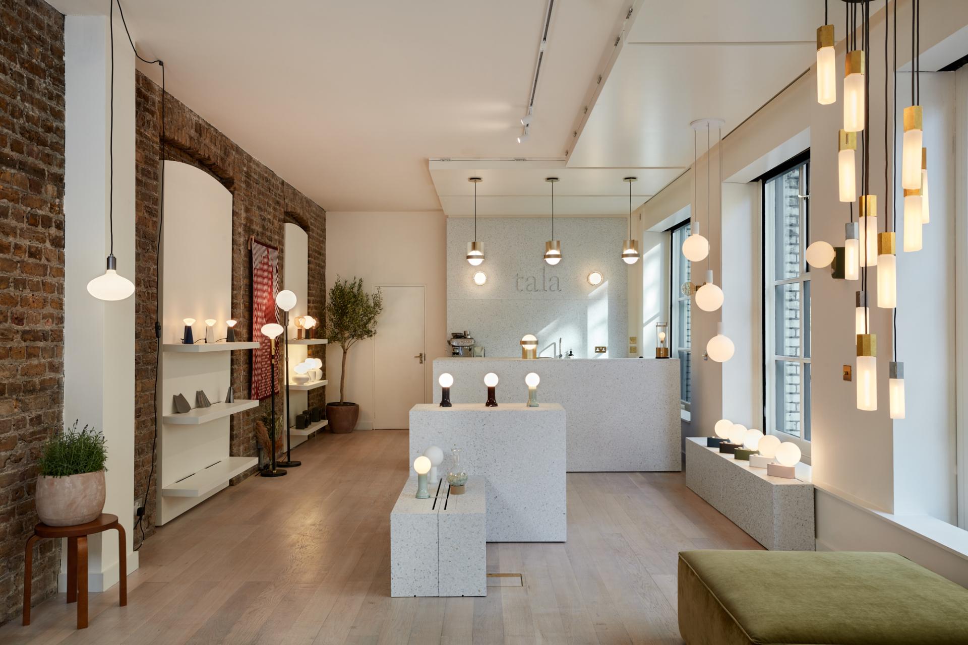 Brightly lit Shoreditch showroom featuring Tala's elegant lighting designs, showcasing sustainable materials and modern decor.