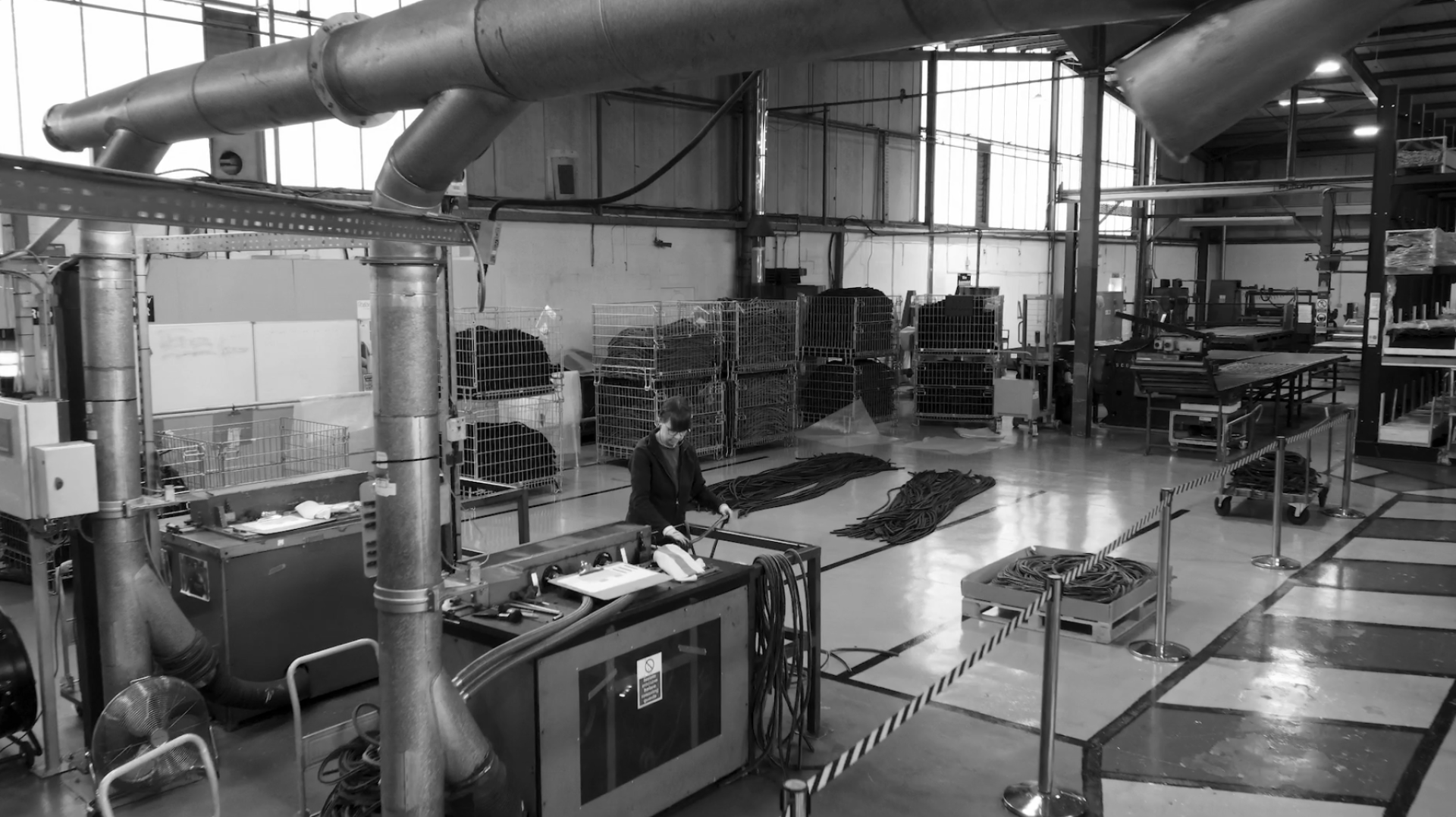 Factory interior at Forbo, showcasing sustainable flooring production with rolls and equipment during the 100-year celebration.