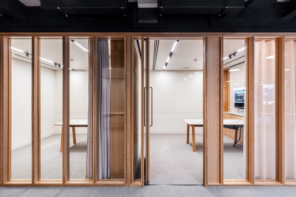 Bespoke timber framed glazed partitioning solution in an office space designed for Boston Consulting Group in London.