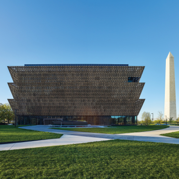 National Museum of African American History and Culture alongside the Washington Monument, showcasing modern architectural design and significant memorials.