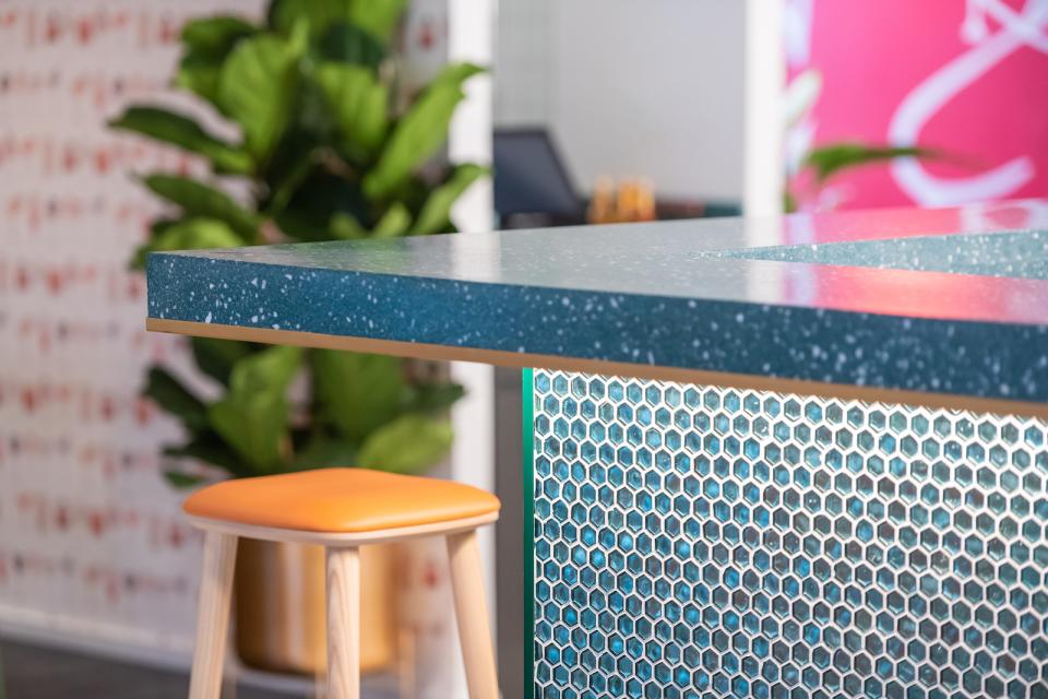 Stylish bar counter featuring a blue speckled surface and geometric design, showcasing modern and playful design elements.
