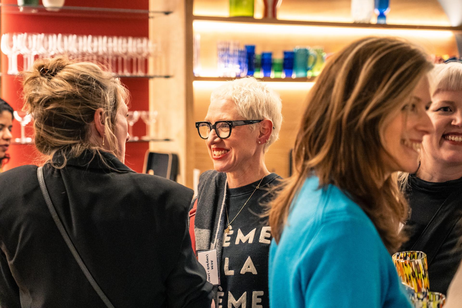 Engaged attendees at the Material Source Studio event in Glasgow discussing sustainability and environmental initiatives.