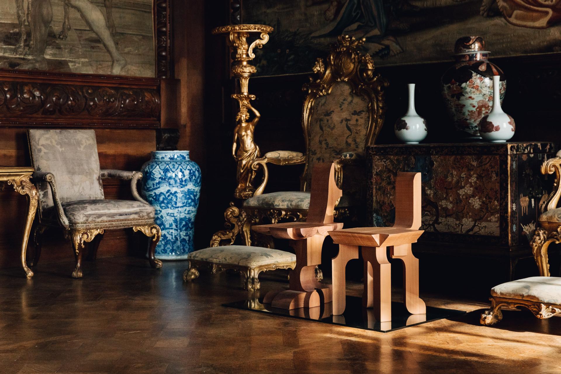 Contemporary wooden stools reflect Chatsworth House's rich heritage and artistic materiality in an elegant interior setting.
