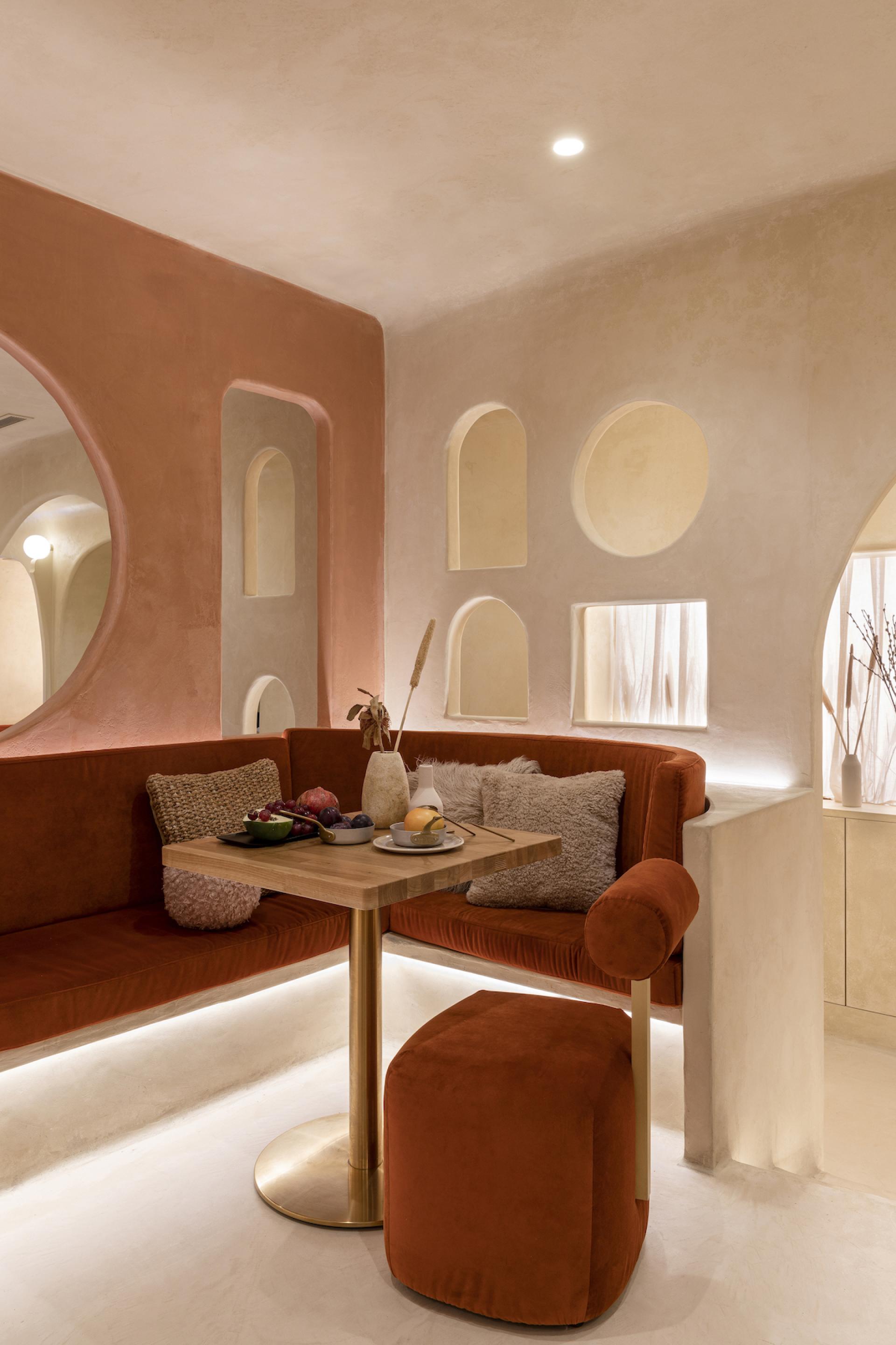 Elegant interior of Living Bakkali restaurant featuring plush seating and Middle Eastern design elements, showcasing fresh fruit and decor.