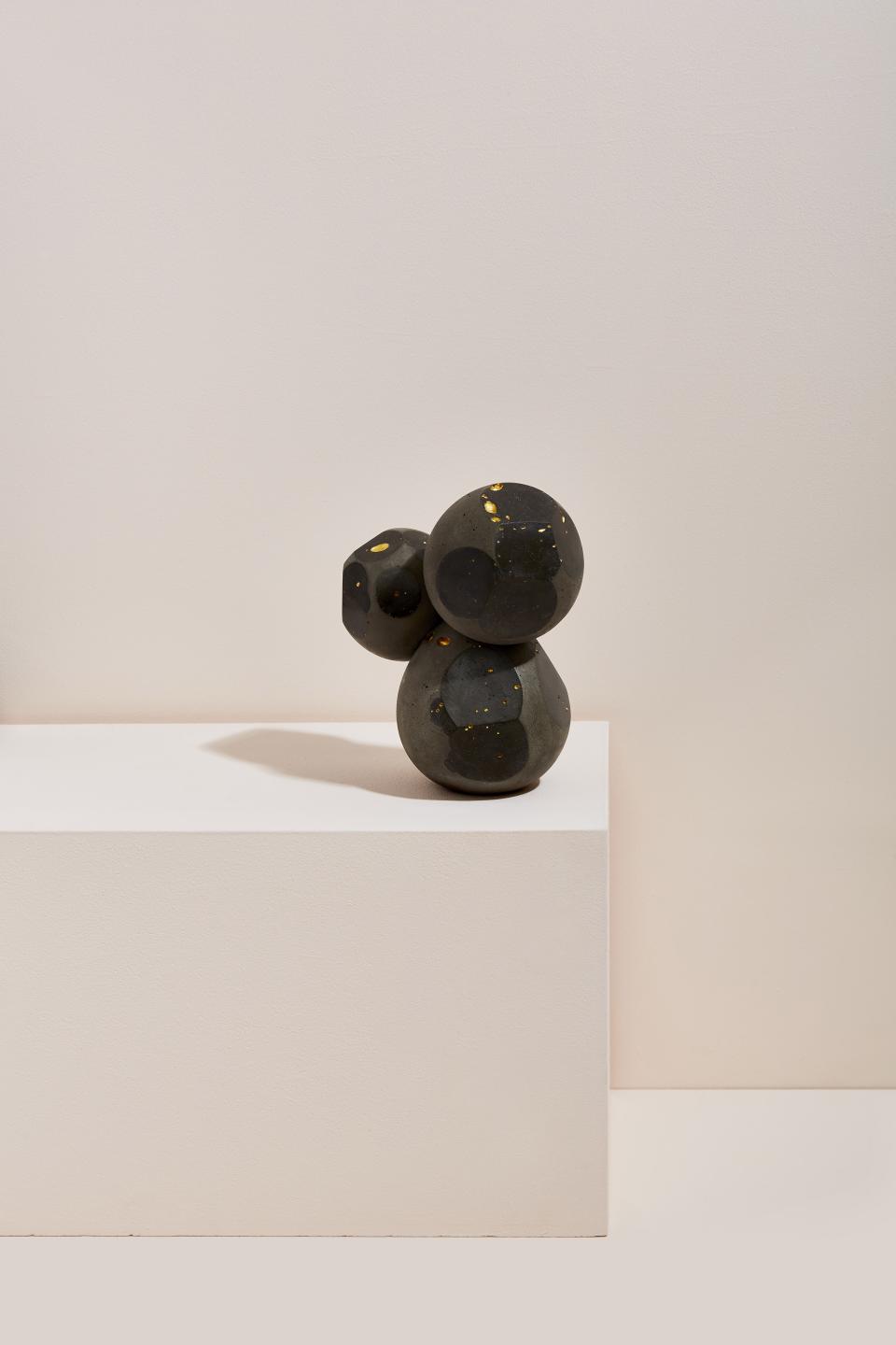 Abstract sculpture composed of black and gold materials, showcasing Vic Wright's innovative approach to form and texture.