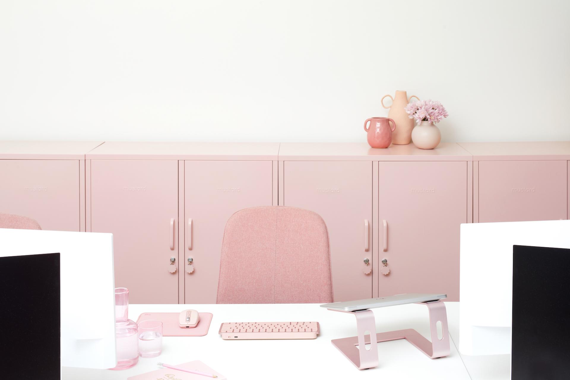 Stylish pink home office featuring Mustard Made cabinets, modern desk setup, and playful decor elements for a creative workspace.
