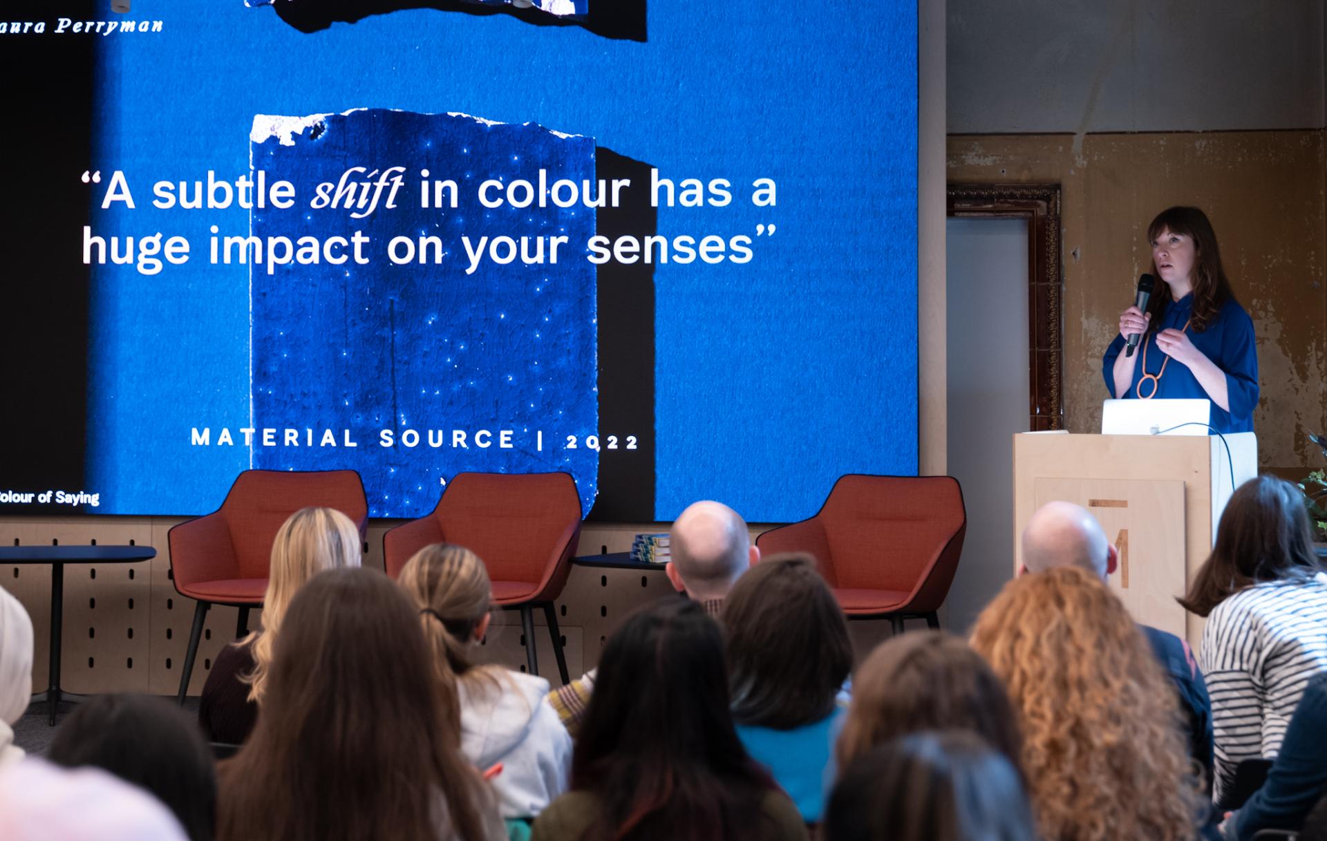 Laura Perryman presents on color theory, emphasizing its sensory impact, at a workshop in Manchester Metropolitan University's School of Art.