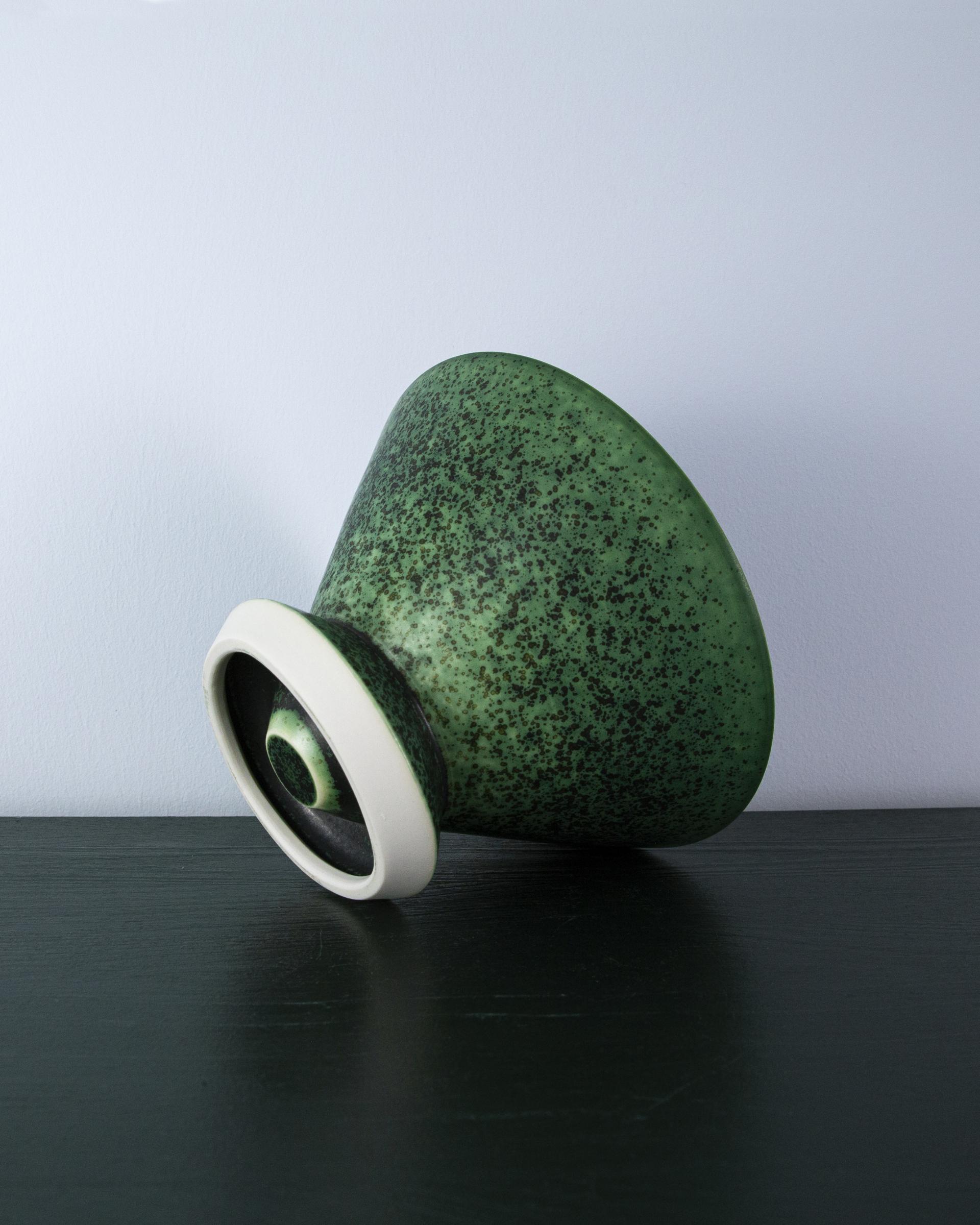 Unique green ceramic vase with a speckled texture, showcasing Ewan Crallan’s playful yet purposeful design aesthetic.