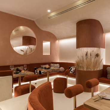 Elegant dining space in Living Bakkali, featuring Middle Eastern-inspired design with warm tones and unique furnishings.
