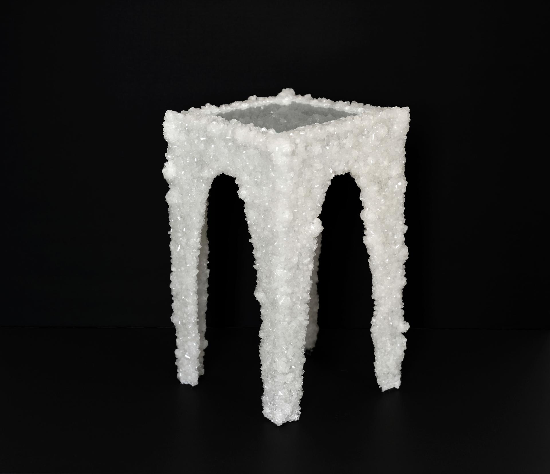 Unique white crystal side table with an architectural design, showcased at New Designers 2024 event.