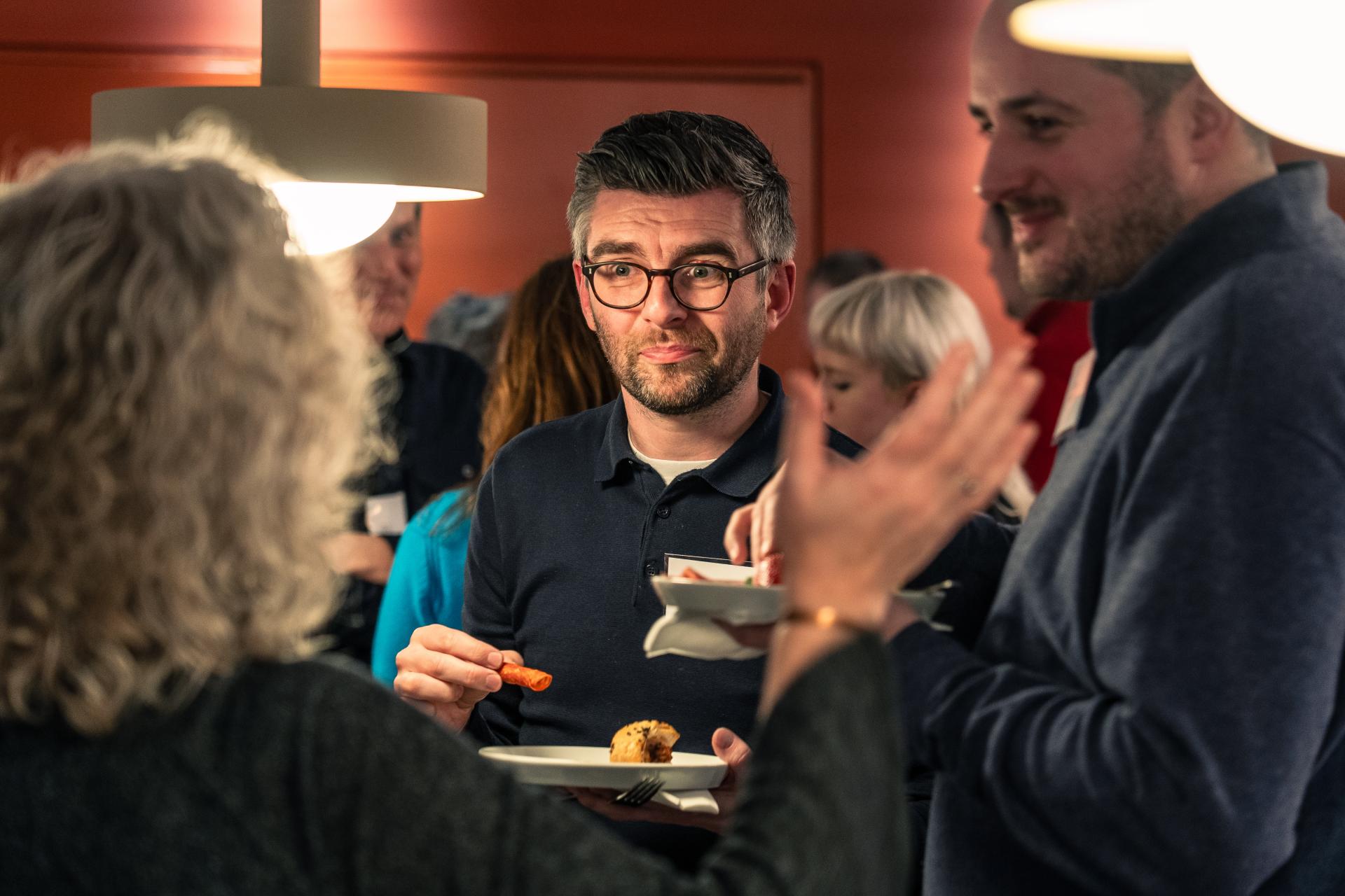 Networking event attendees discuss sustainability over snacks at Material Source Studio in Glasgow.