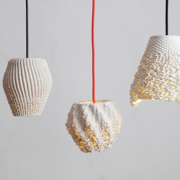 Three uniquely designed 3D printed lamps made from recycled ceramics, showcasing sustainable and parametric design elements.