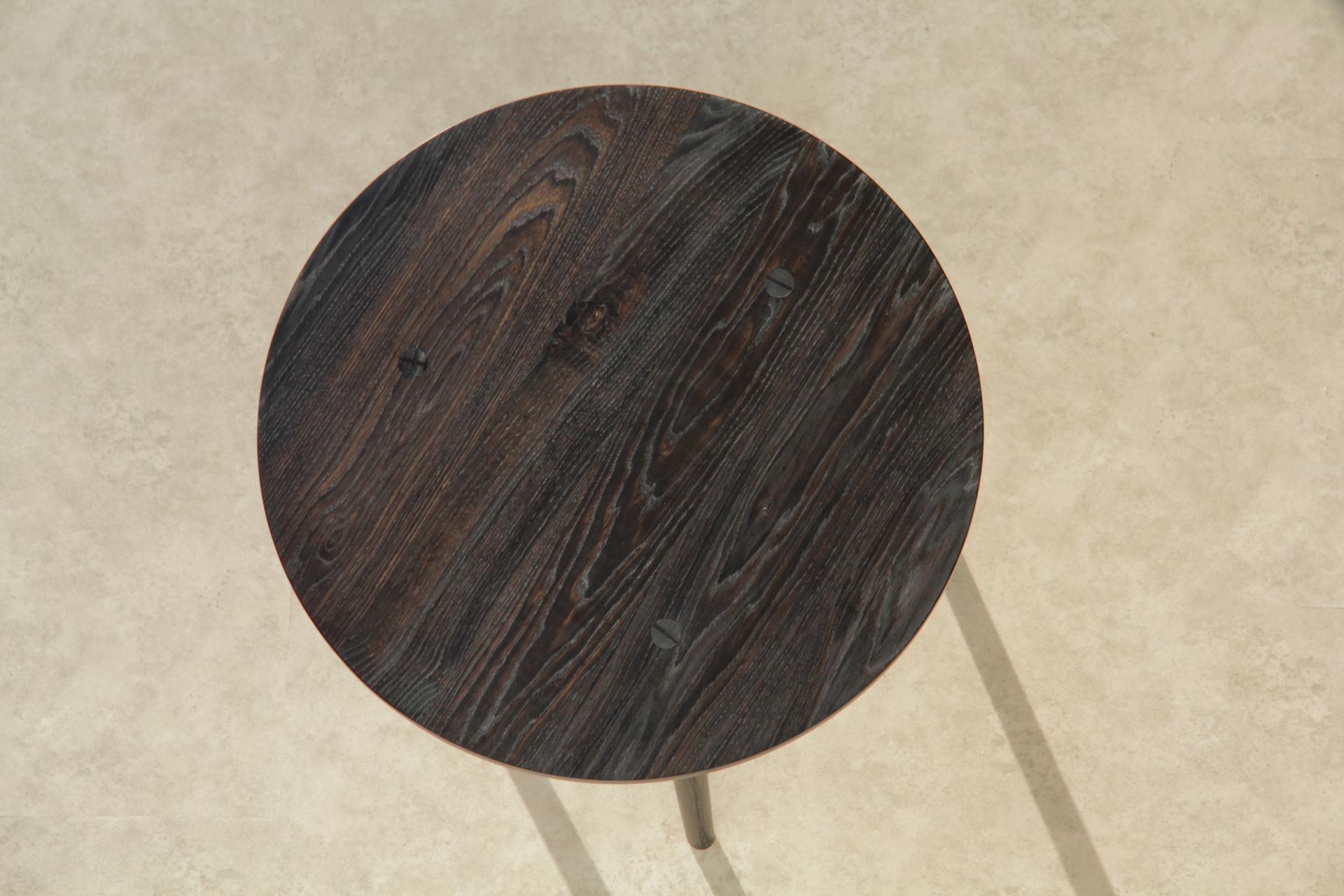 Artisan-crafted round wooden table showcasing rich textures, part of Jesse Cracknell's maker in residence project.