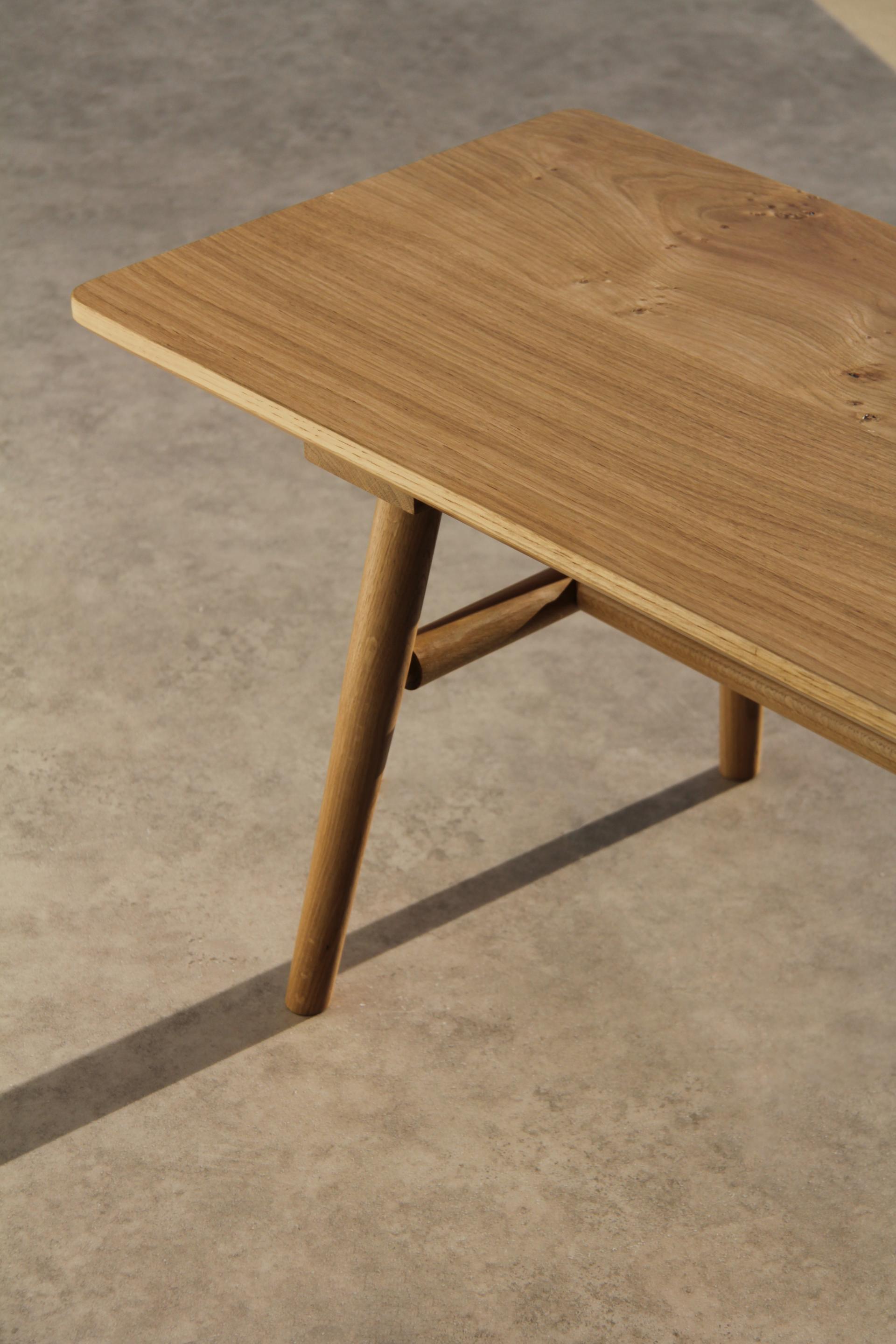 Elegant wooden table with tapered legs, showcasing craftsmanship by maker-in-residence Jesse Cracknell at NOMA.