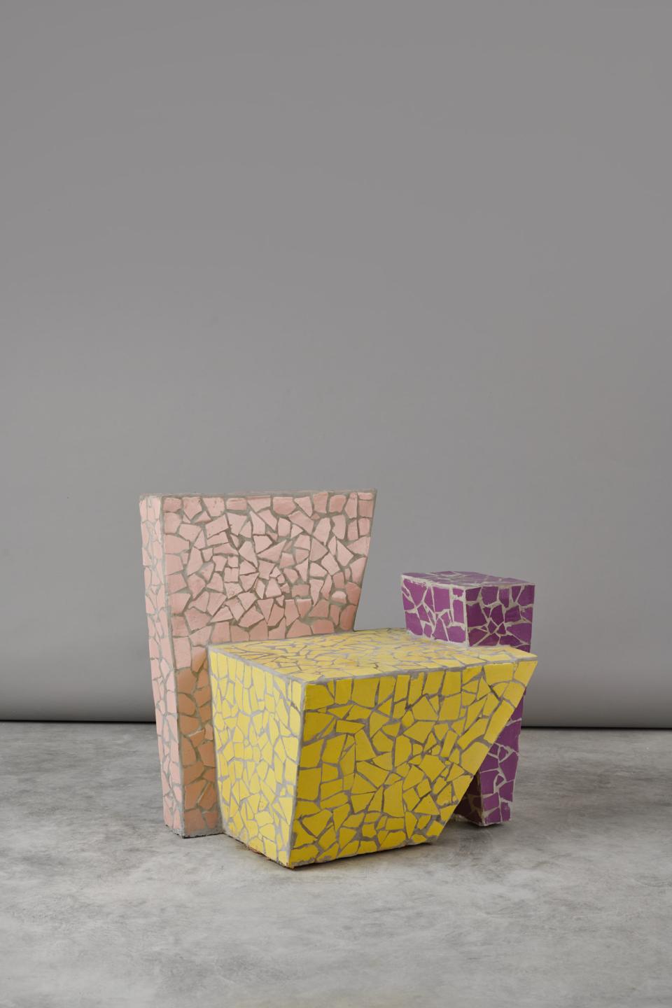 Colorful mosaic chairs in pink, yellow, and purple, representing friendship and creativity in furniture design.