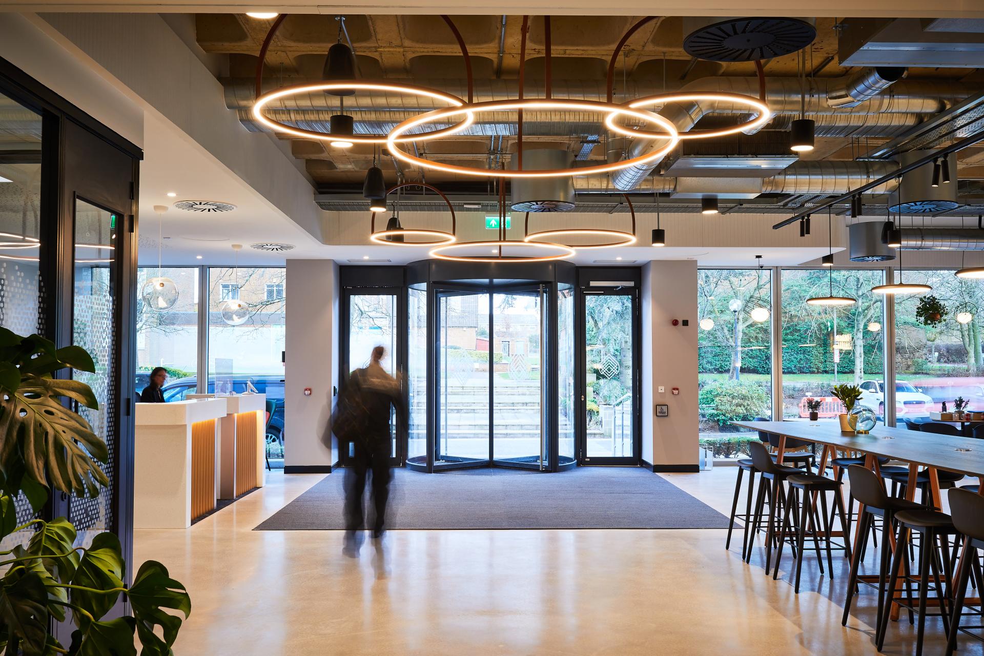 Modern reception area of Central House, Harrogate, featuring sleek design, ambient lighting, and vibrant greenery.