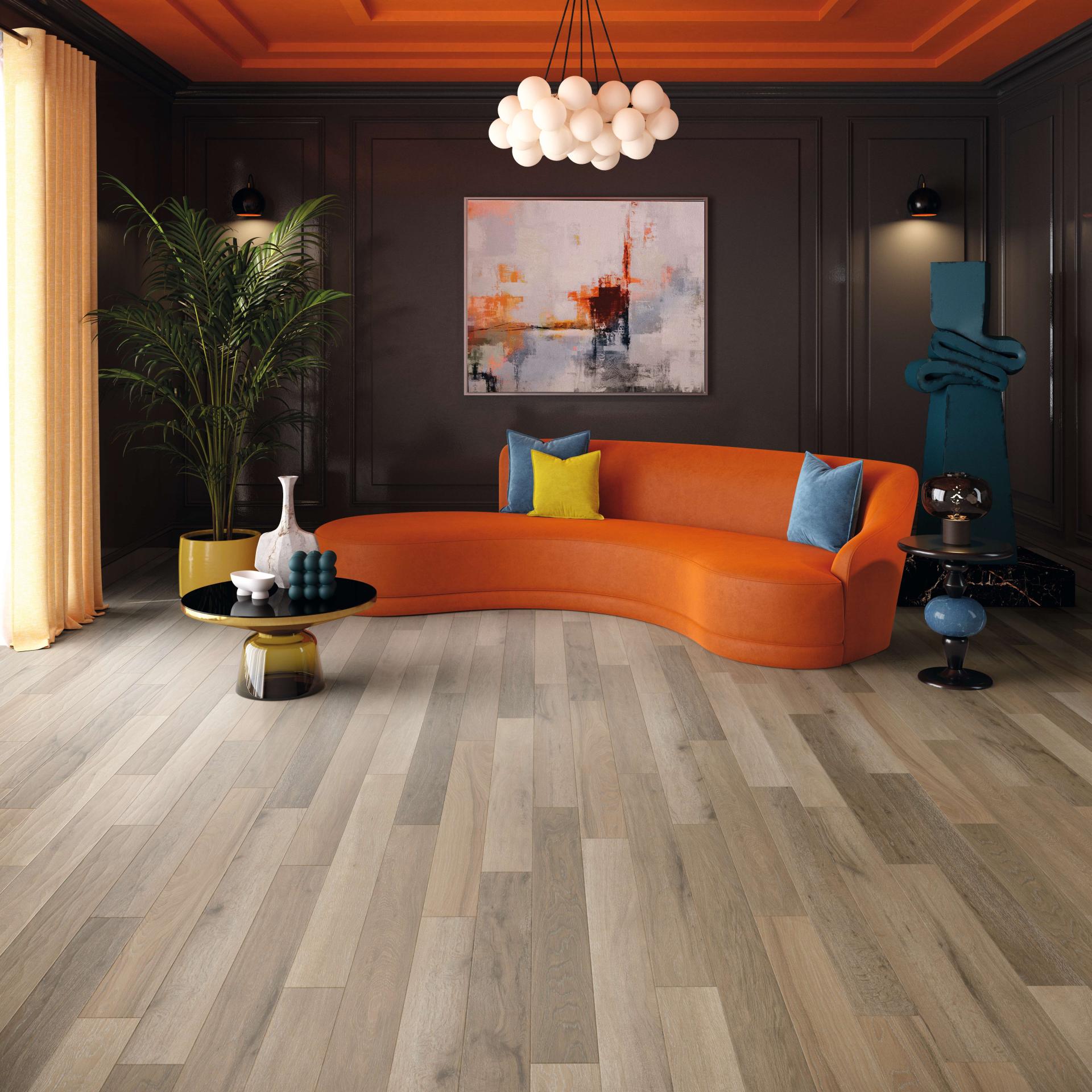 Modern living room showcasing Karndean's elegant wood-style flooring, complemented by a vibrant orange sofa and contemporary decor.