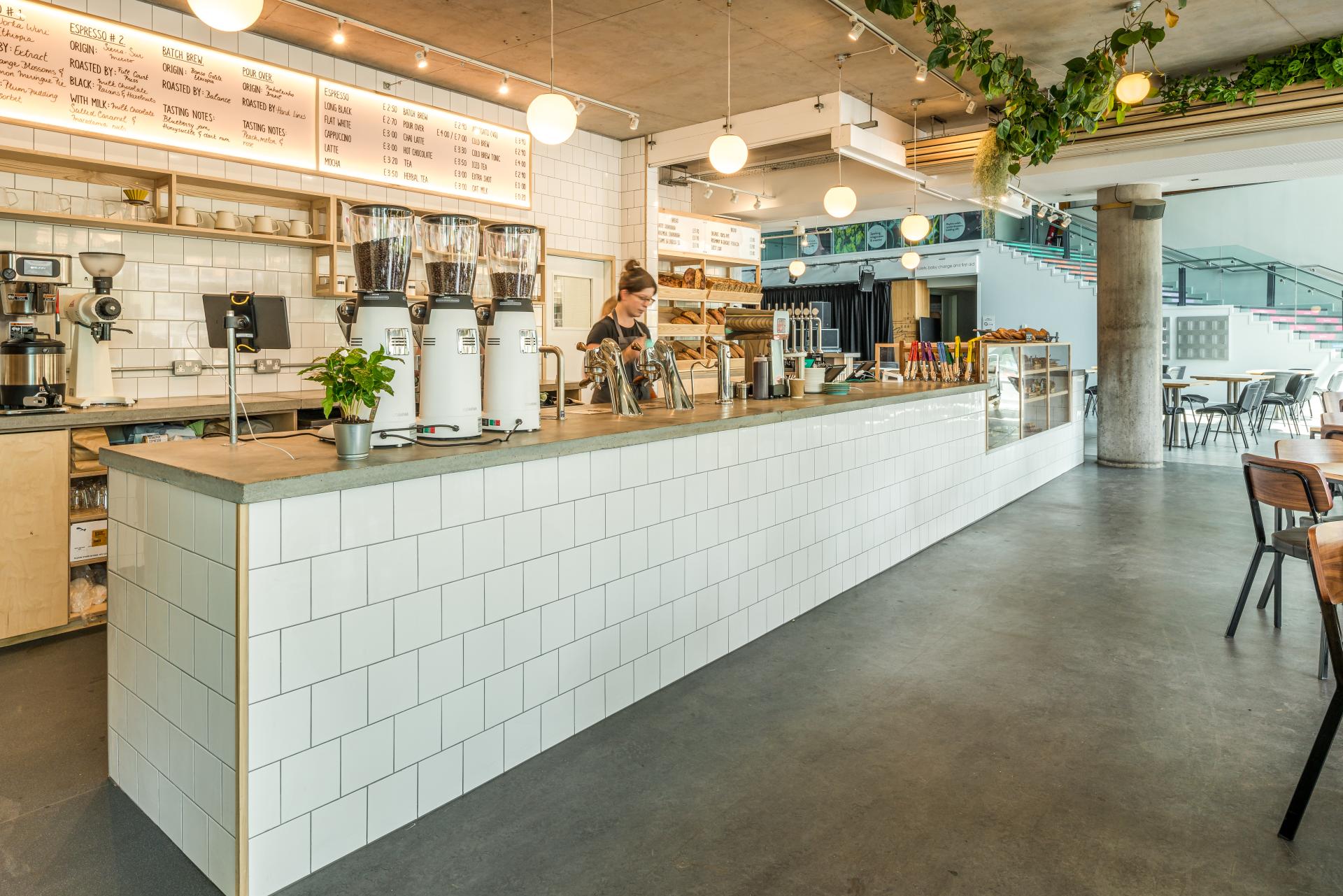 Bright and modern café interior of Bristol Loaf featuring a coffee counter and baked goods at Bristol Beacon.