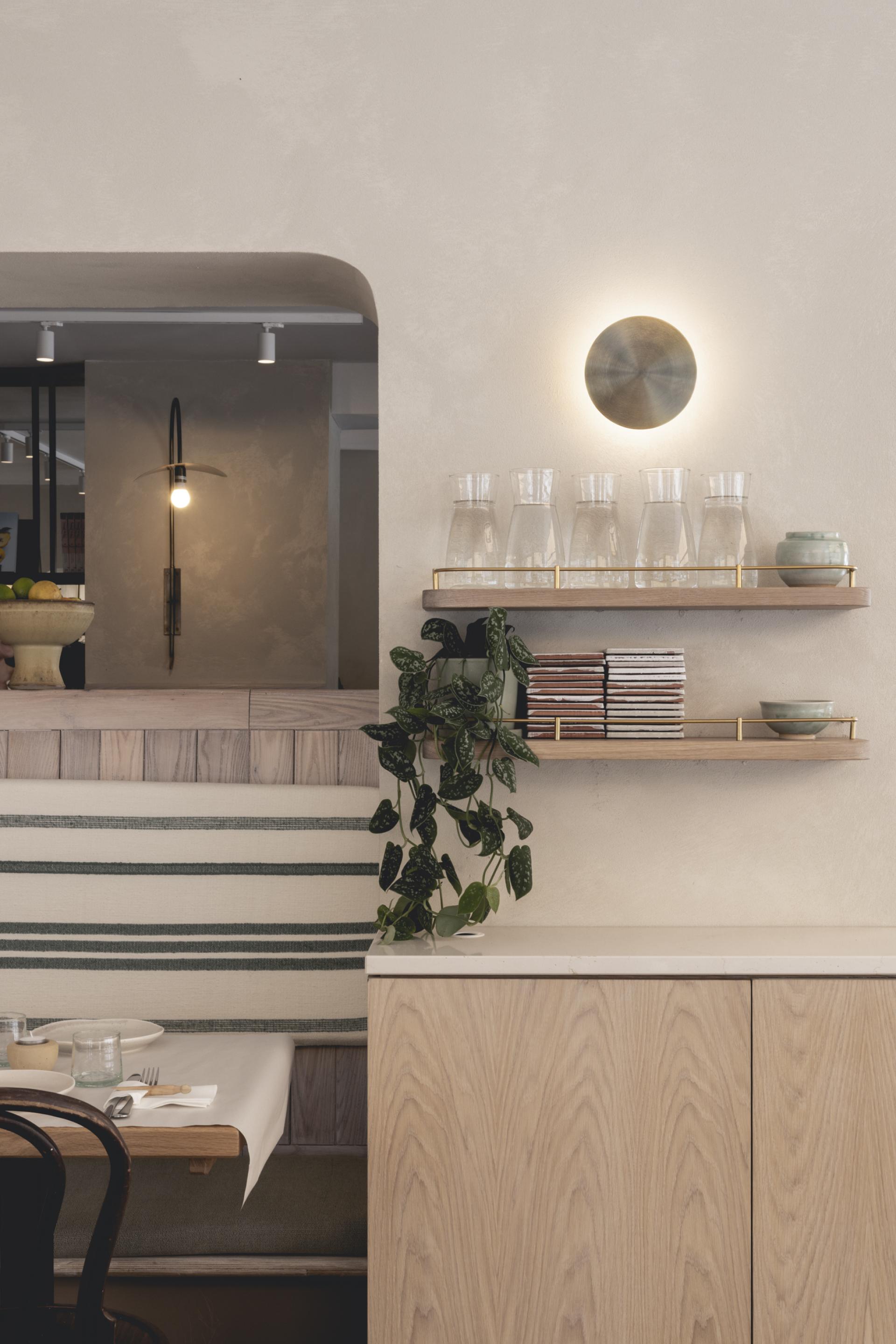 Elegant interior of Honey & Co Bloomsbury featuring natural materials, modern lighting, and stylish decor elements.