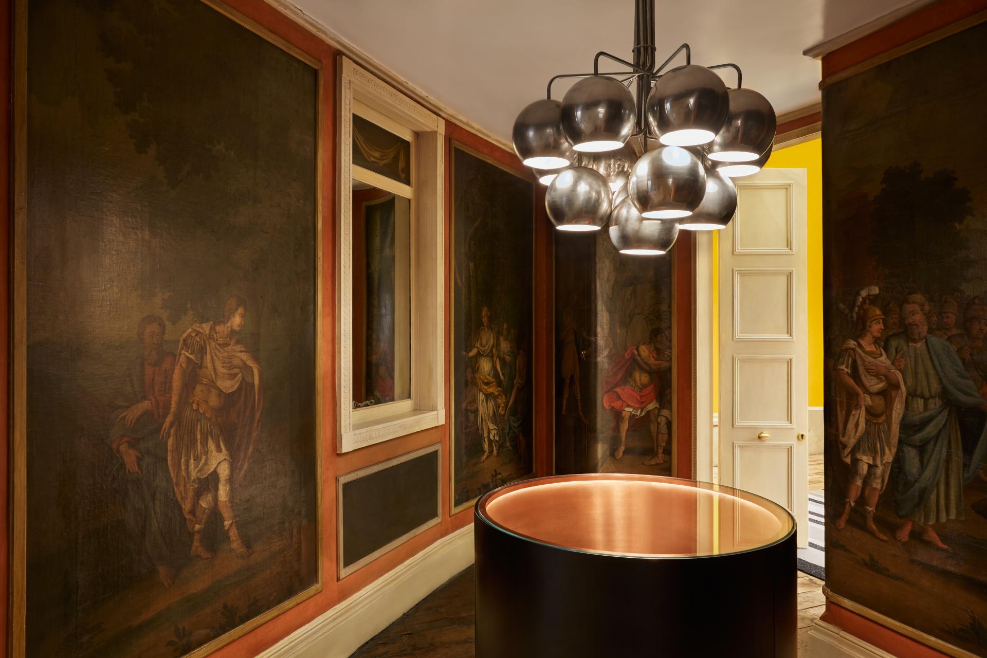 Luxurious retail interior featuring Nulty's modern lighting design and classic murals in Browns, London.