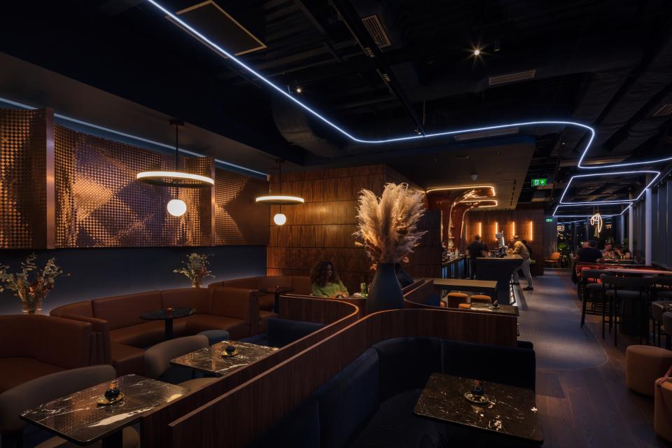 Stylish interior of M'Arks Sky Bar featuring modern seating, ambient lighting, and a vibrant bar area in London.