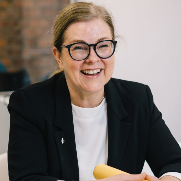 Kim Ebling, director of decarbonisation at Corstorphine & Wright, smiling during a discussion about AI and social housing challenges.