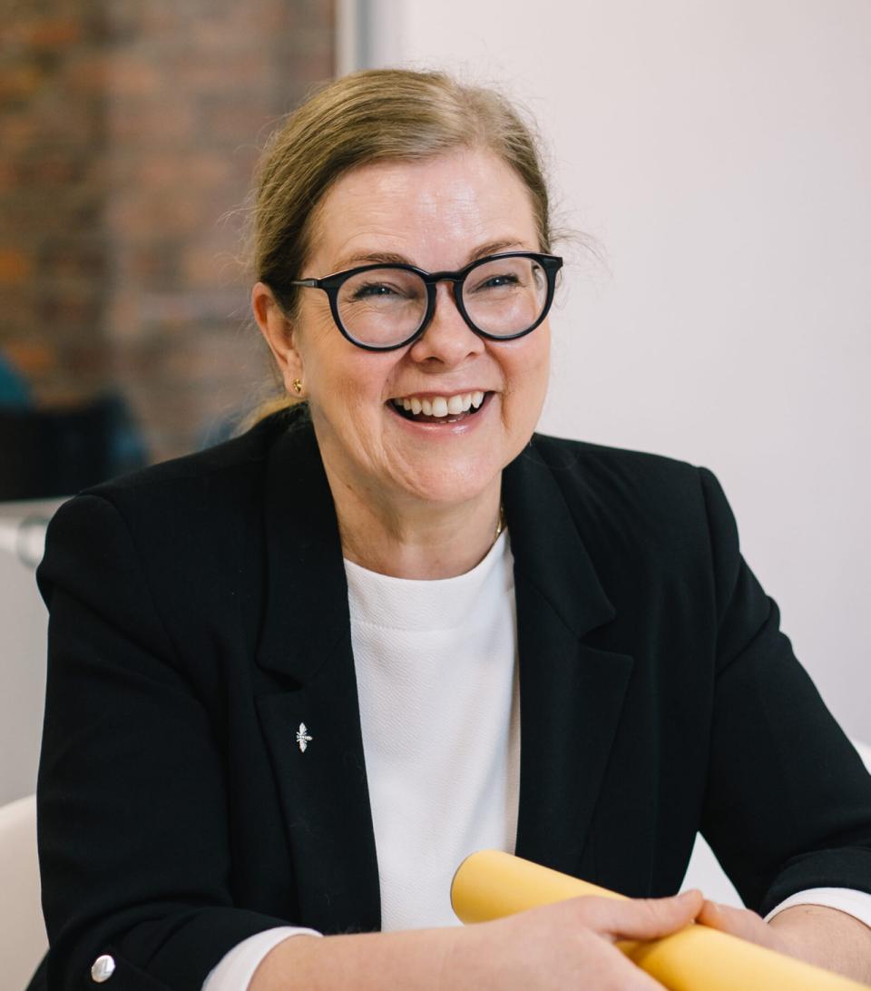 Kim Ebling, director of decarbonisation at Corstorphine & Wright, smiling during a discussion about AI and social housing challenges.