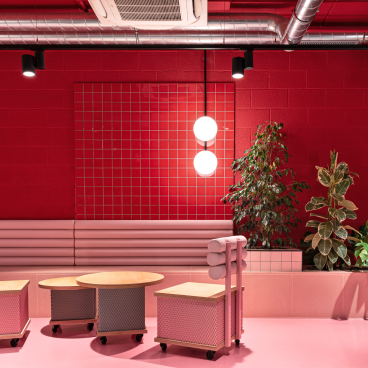 Vibrant Wes Anderson-inspired interior of a student residence, featuring unique furniture and a bold color palette.