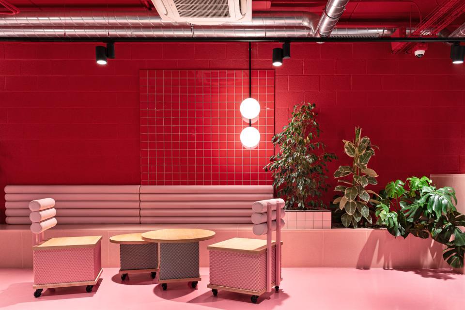 Vibrant Wes Anderson-inspired interior of a student residence, featuring unique furniture and a bold color palette.
