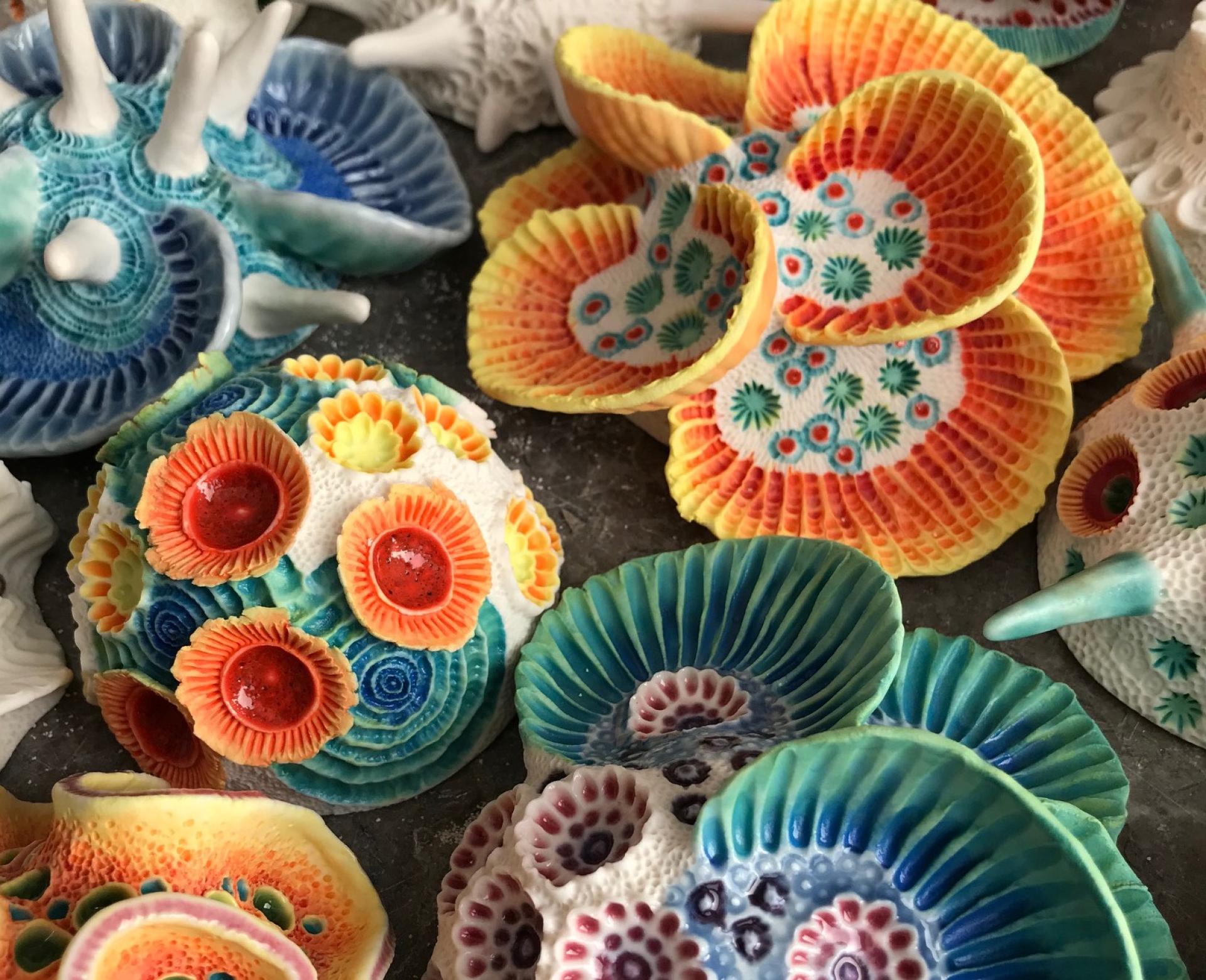 Vibrant clay sculptures of seashells and marine life by Aardman Animations artist, showcasing intricate designs and oceanic beauty.